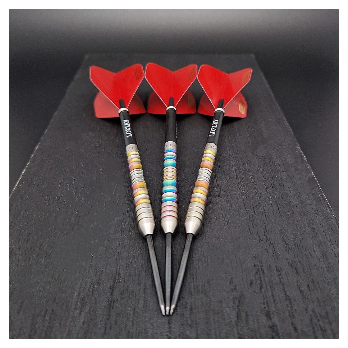 Loxley Excalibur Model 1 95% Tungsten Steel Tip Darts laid on a wooden block