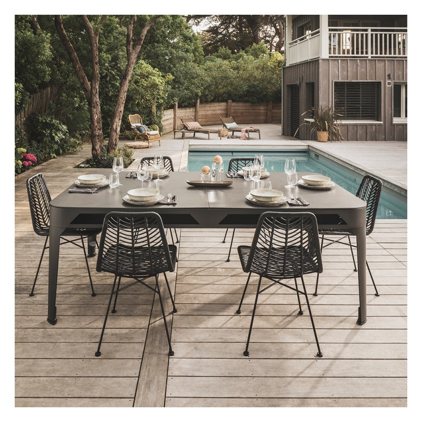 Cornilleau HYPHEN Outdoor Pool Table - Black Frame / Dark Grey Cloth pictured with the optional grey mineral table cover poolside as an outdoor dining table